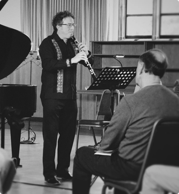 a man plays a wind instrument to fellow church-goers